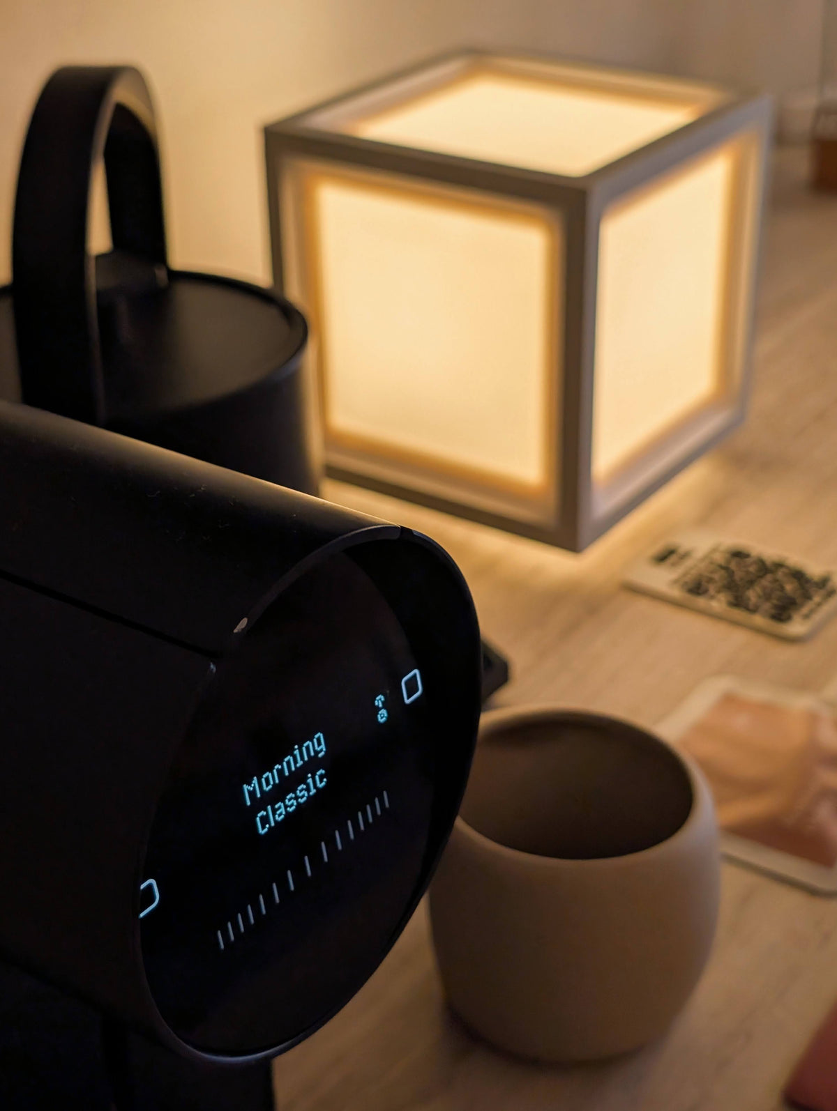 HAKO lit on a desk beside a coffee grinder